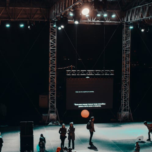 Group of People Standing on Stage